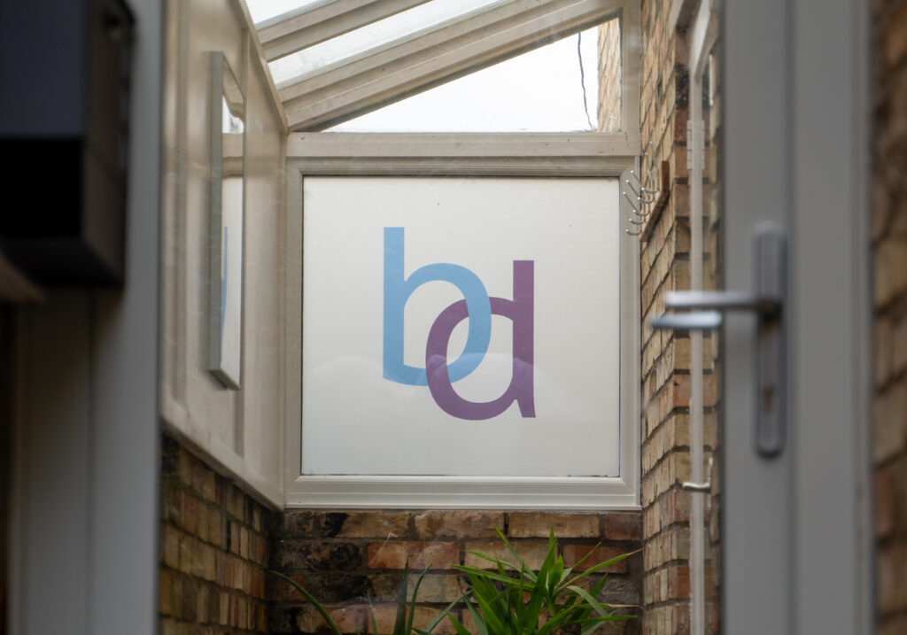 Anti-wrinkle Treatments Cambridge. Image is a photo of the Burnside Dental logo on one of our windows.